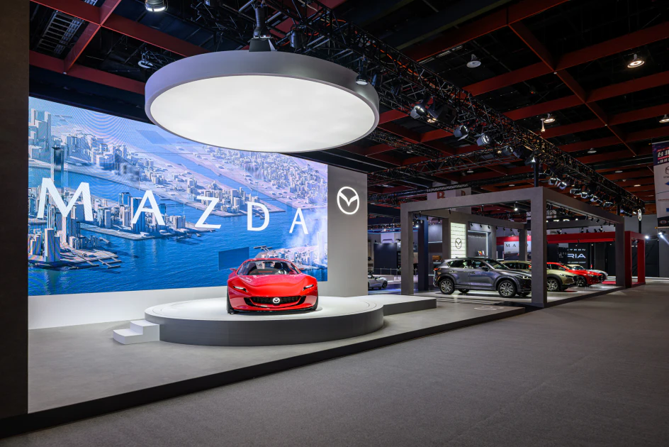 2026 台北車展，MAZDA 以首度在台亮相的全新品牌標誌揭開序幕，結合「Smile Every Mile」主軸打造旅程式展區，依循駕馭旅程的鋪陳，規劃「駕趣起程」、「自在風格」、「後驅工藝」與「馭動未來」四大體驗篇章。